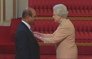 Zulfi Hussain receiving his MBE from Her Majesty The Queen